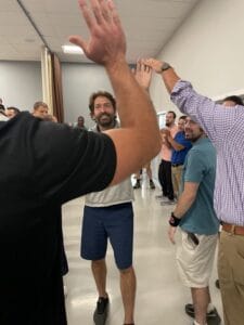 men high-fiving at a gathering