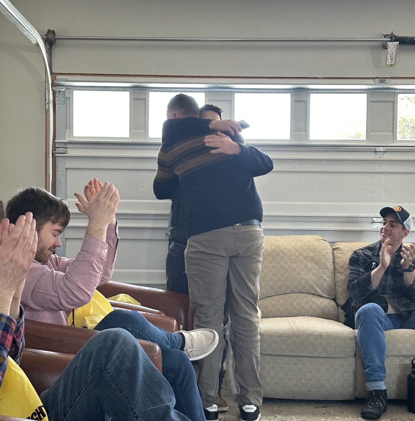 men hugging in a meeting