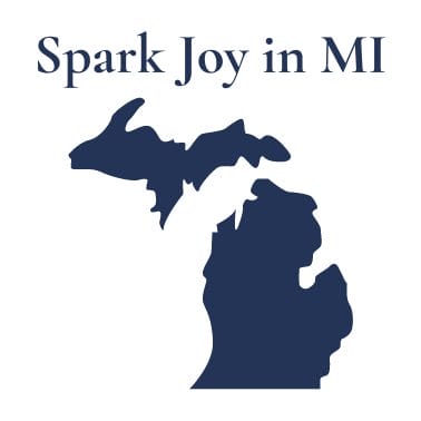 outline of michigan with spark joy in michigan above it