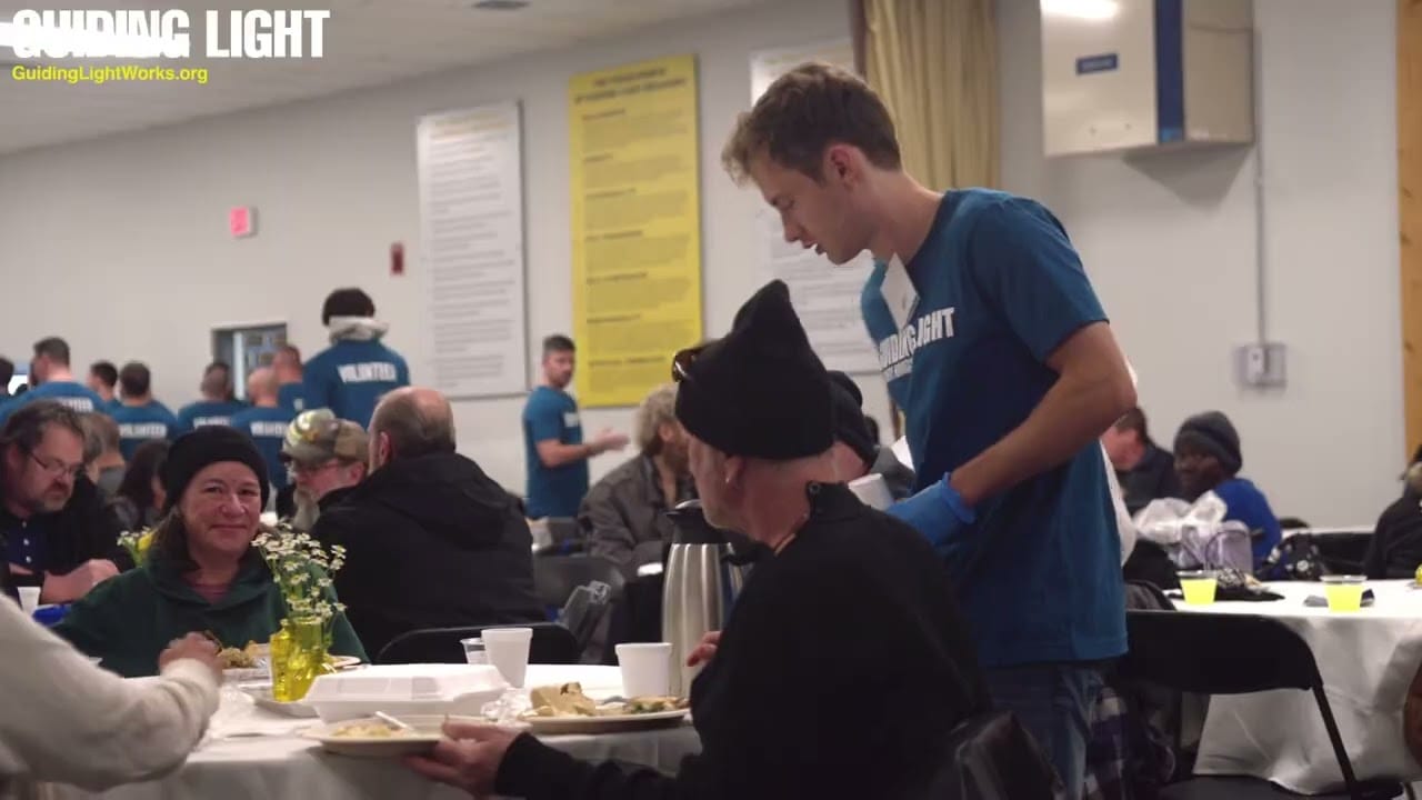 volunteer serving diners at thanksgiving dinner